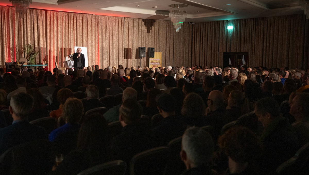 Comedian holding the mic at the Dún Laoghaire Comedy Festival